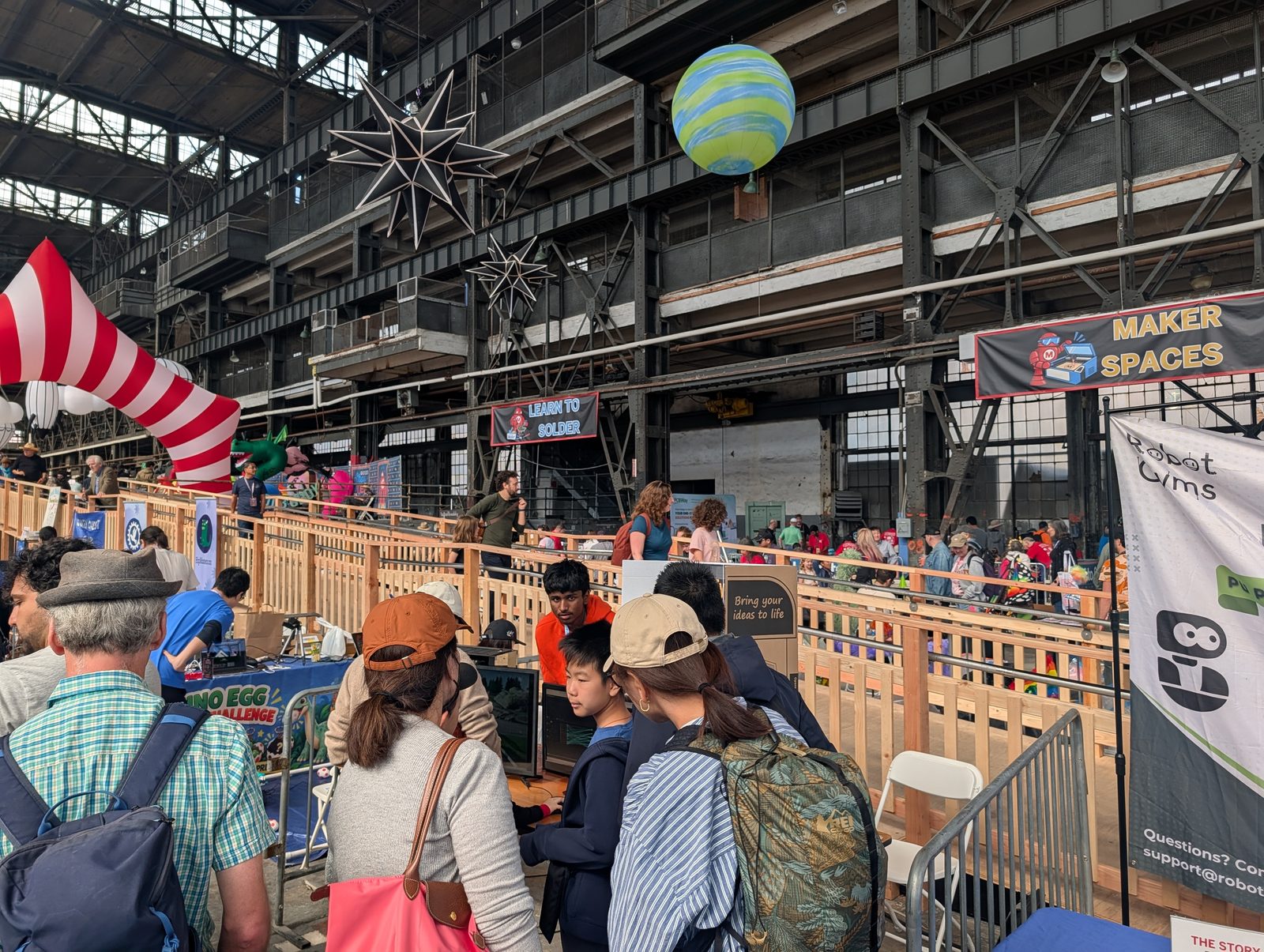 A crowd around the AOST booth in the Maker Spaces hall